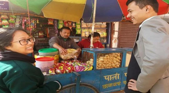 Image of two students going to eat street food